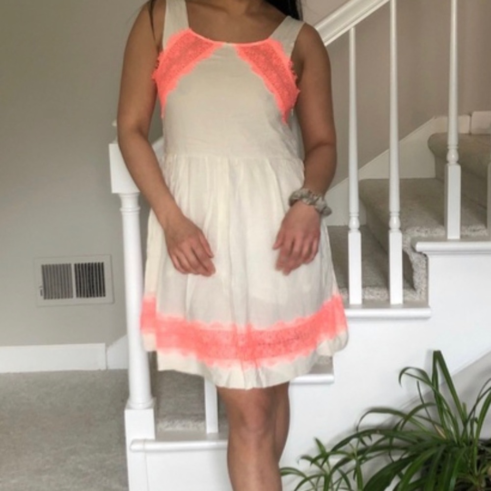 Free people 
Beautiful cream dress with neon pink lace accents.